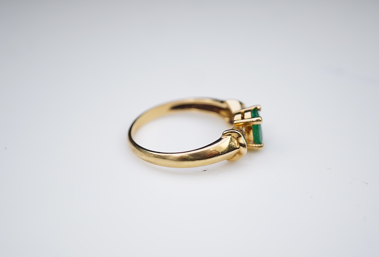An emerald and diamond ring